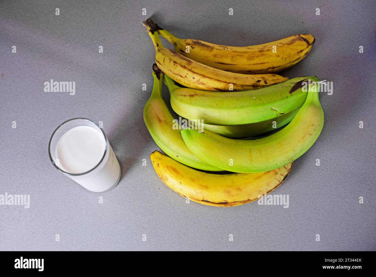 glass of banana milk next to a bunch of bananas Stock Photo - Alamy