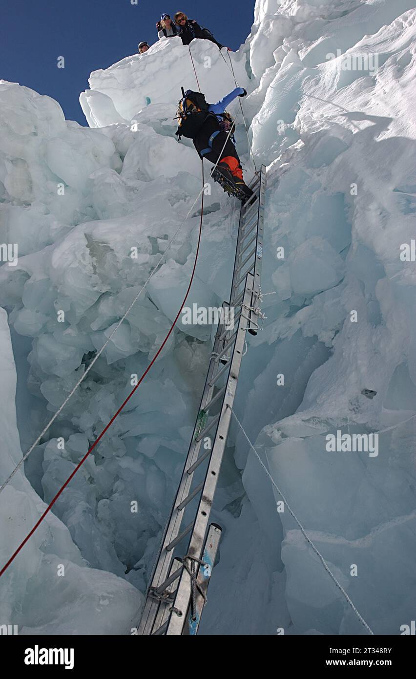Climber on ladder on Mount Everest Stock Photo Alamy