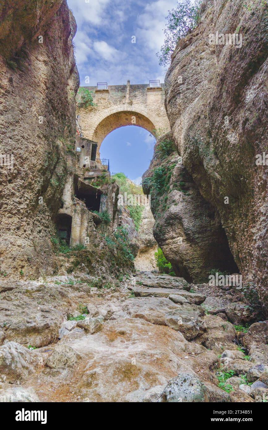stone bridge over a cliff with a dry riverbed Stock Photo