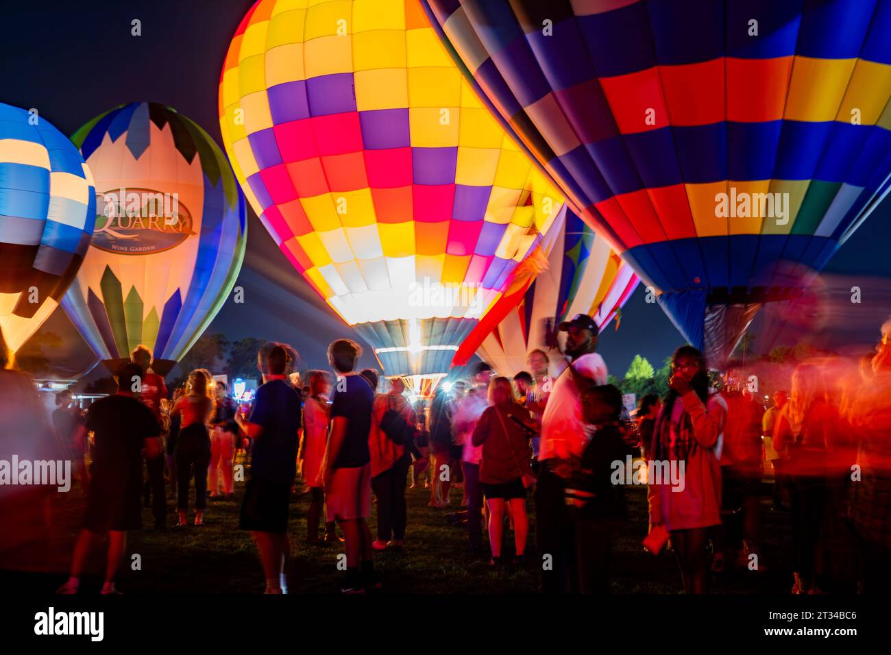 People gather under the glow of Hot Air Balloons Stock Photo