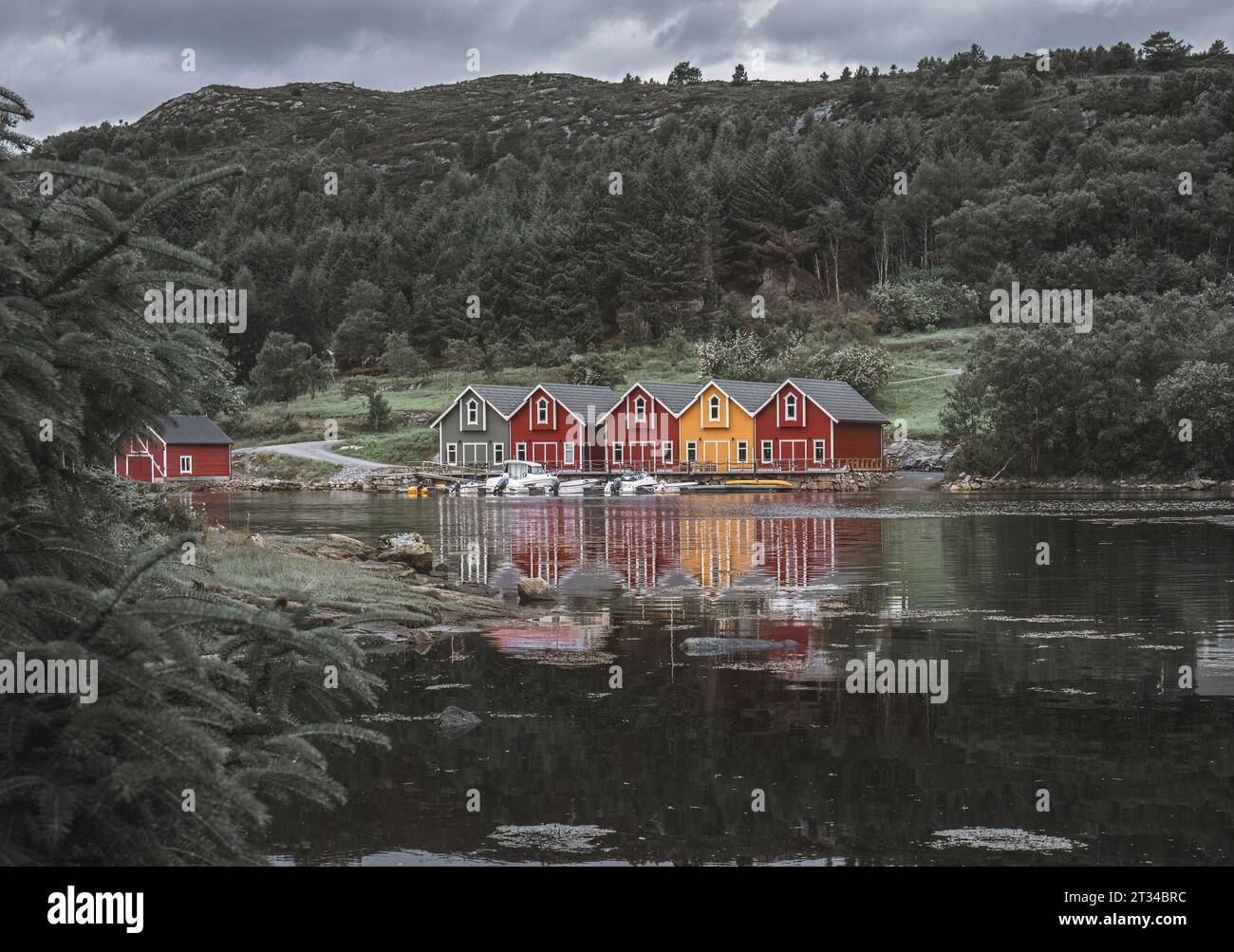 Red and yellow houses on the shore of a fjord in Norway Stock Photo