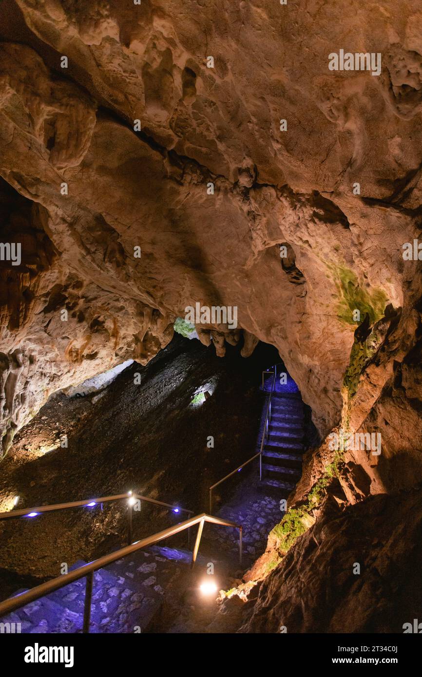 Cave illuminated with yellow and blue lights Stock Photo - Alamy