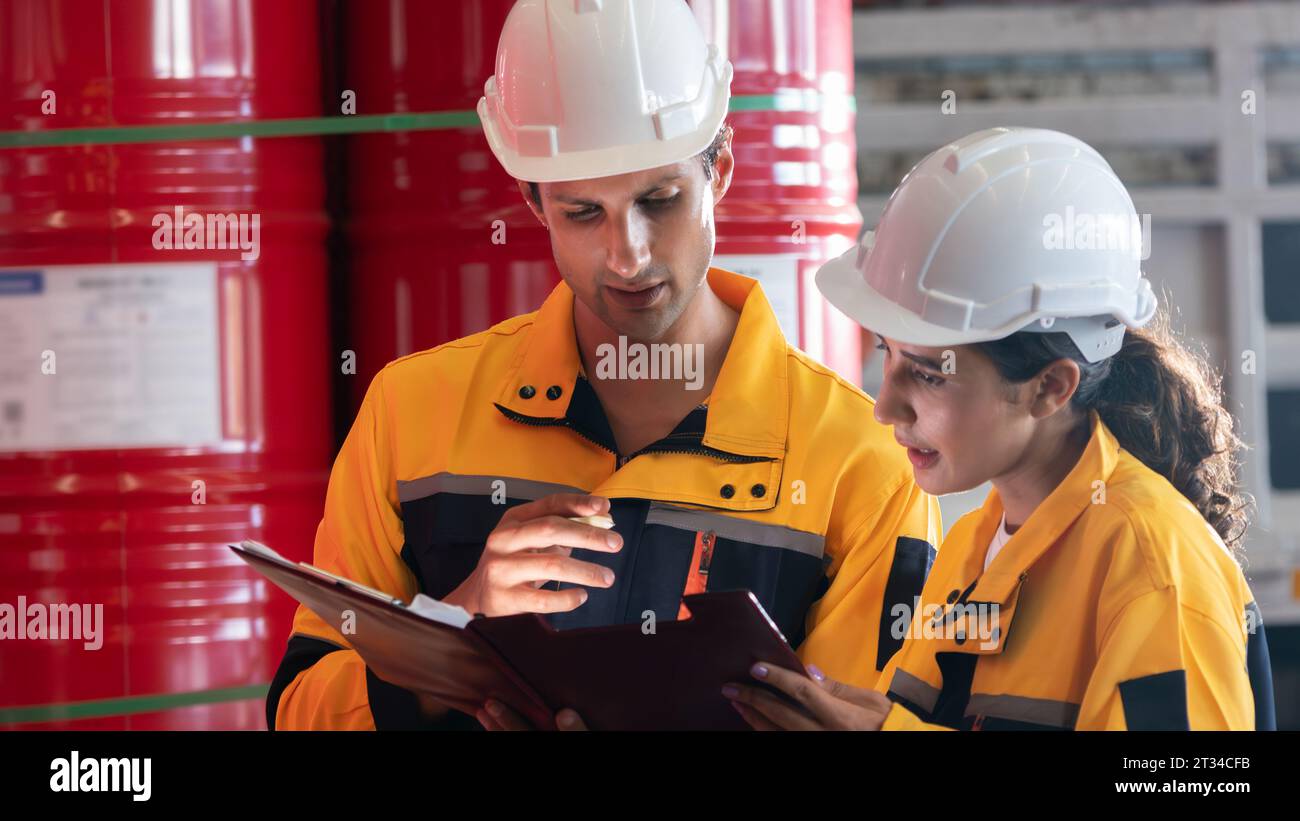 Two factory workers or inventory inspector conduct professional