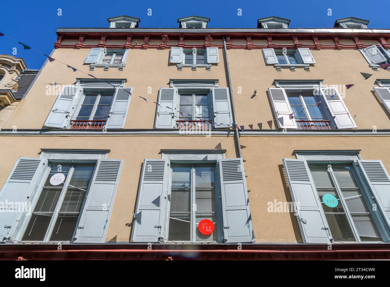 Looking up on iconic French houses with blue shutters on Rue Dalesme