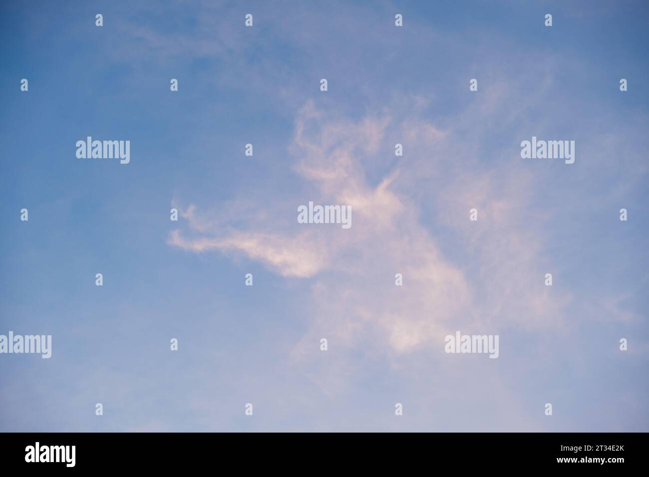 Beautiful Panoramic shot ofWhite Clouds with blue Sky during summer down. Cute view of the evening sky: the glare of the sun on a white cloud in the blue sky. Stock Photo
