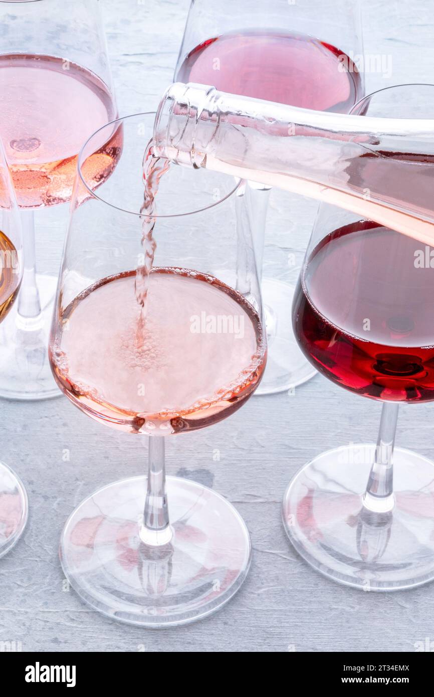 Wine pour into a glass at a tasting. Rose and red wines, drinks on a