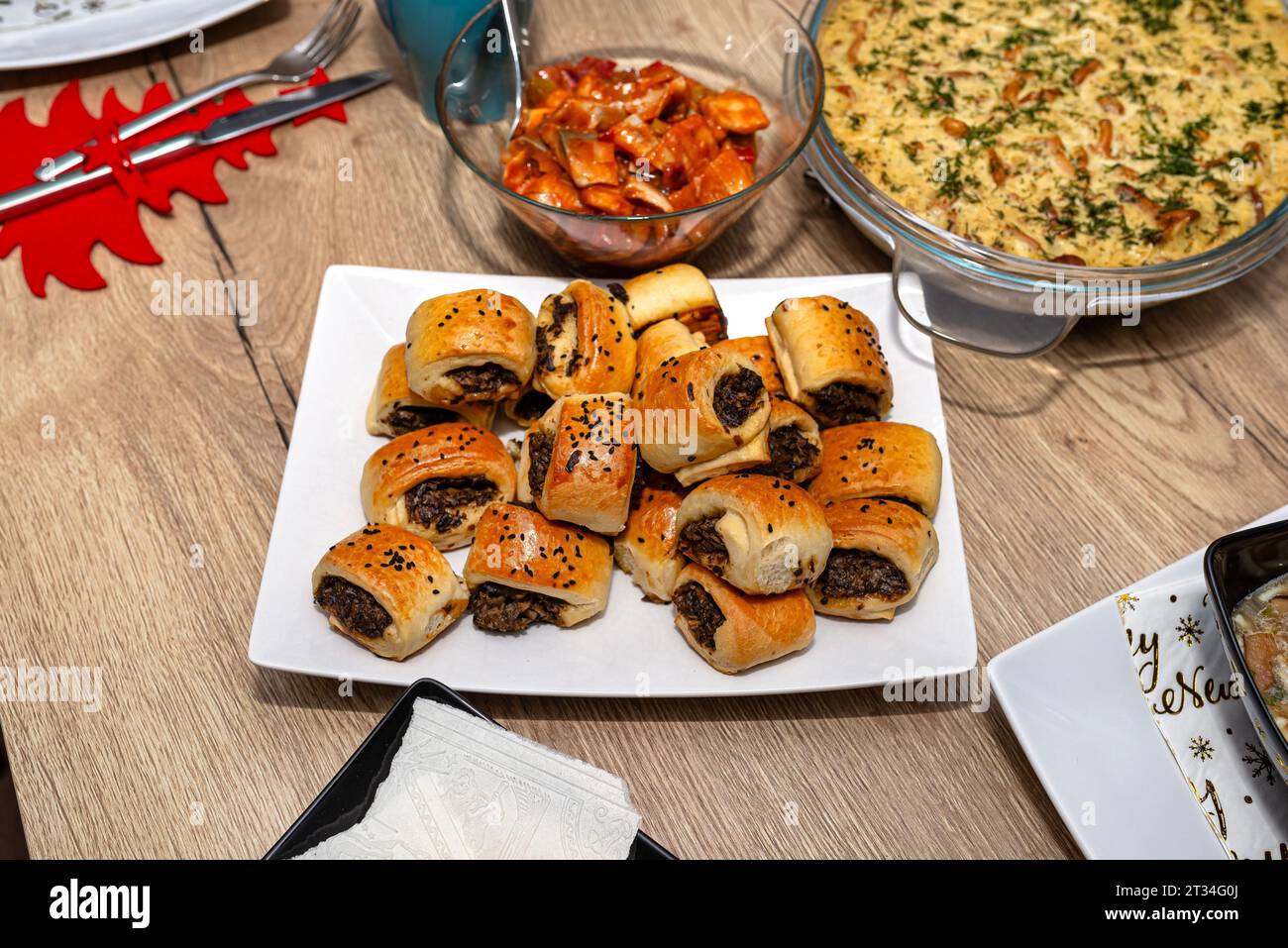 Baked patties in dough lying on a plate on a Christmas table in Poland. Stock Photo