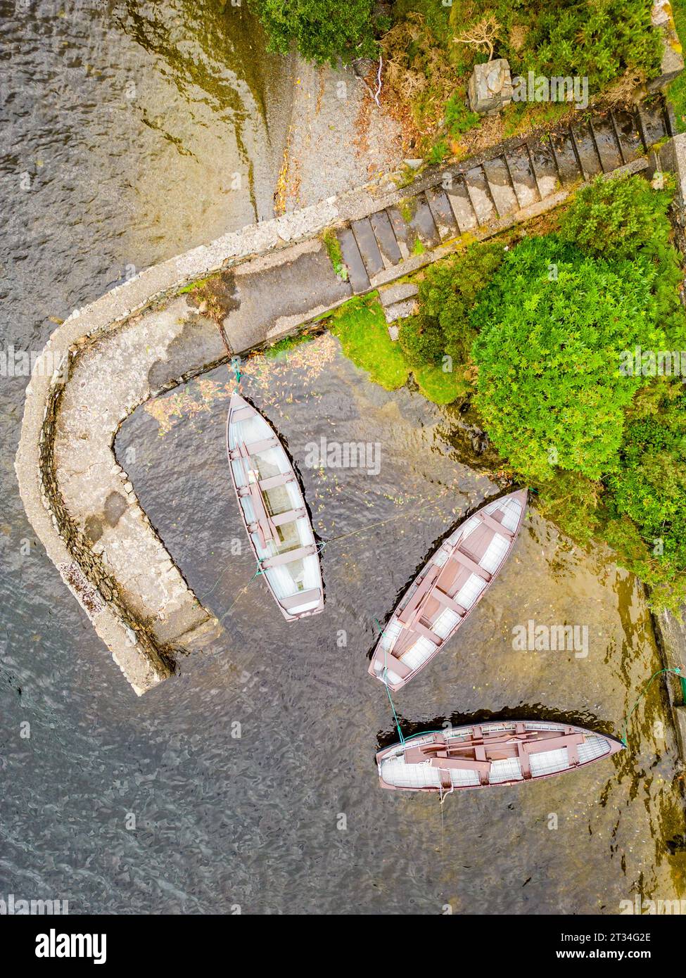 Small pier with three boats in Doo Lough, Delphi, County Mayo, Ireland