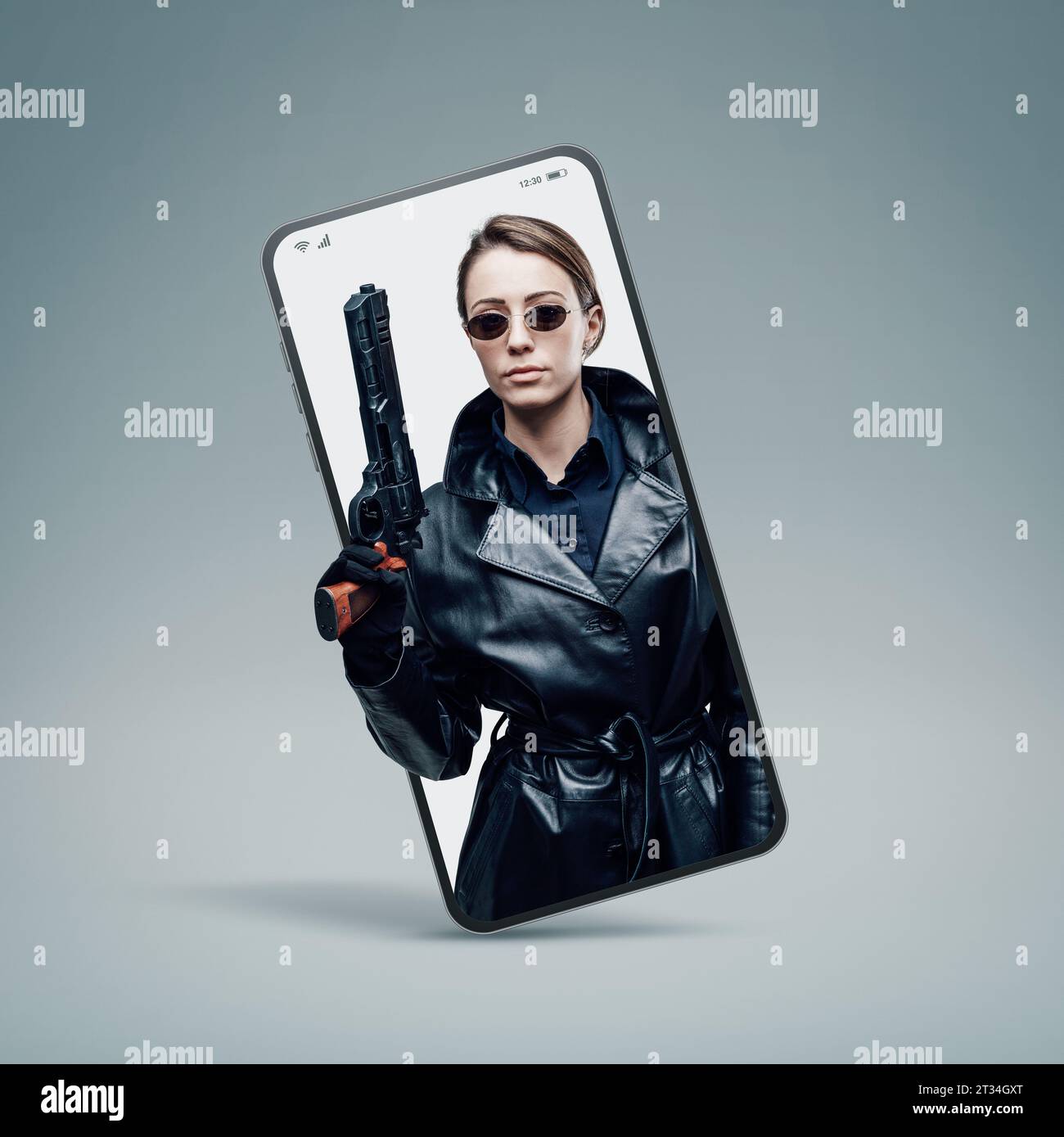Cool female spy agent in black leather coat in a smartphone videocall Stock Photo