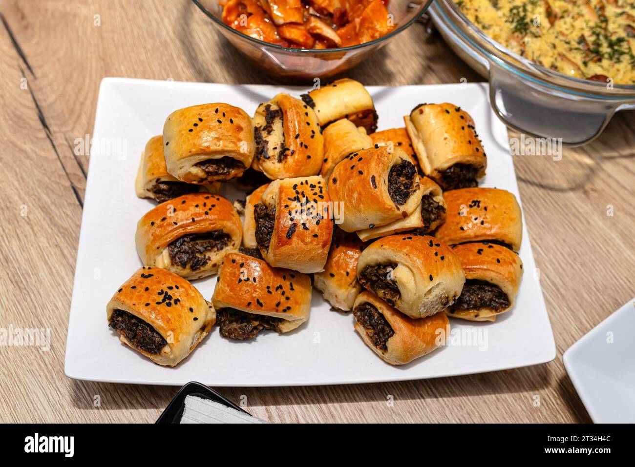 Baked patties in dough lying on a plate on a Christmas table in Poland. Stock Photo