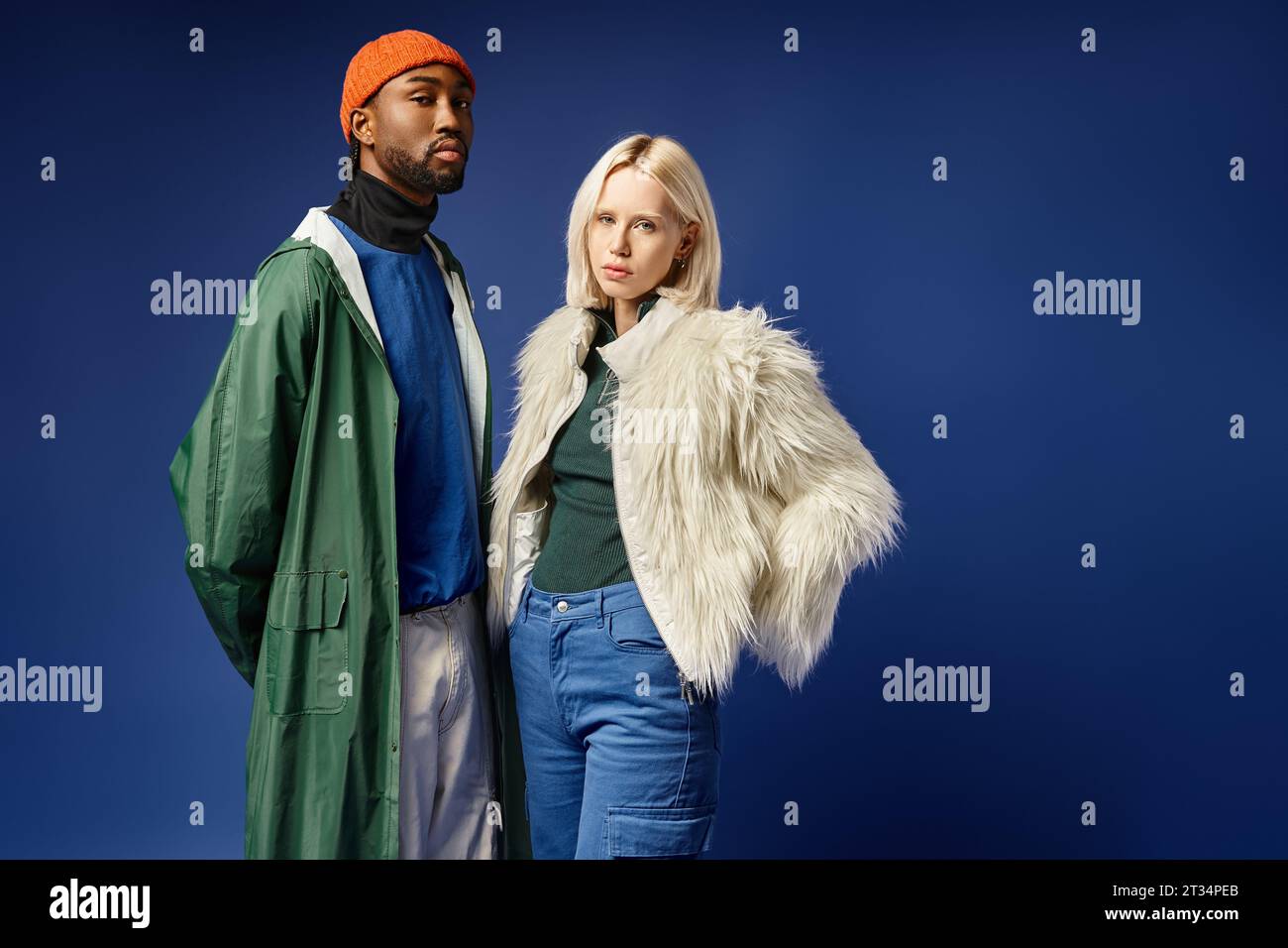 young multicultural couple, attractive woman in faux fur jacket and handsome african american man Stock Photo