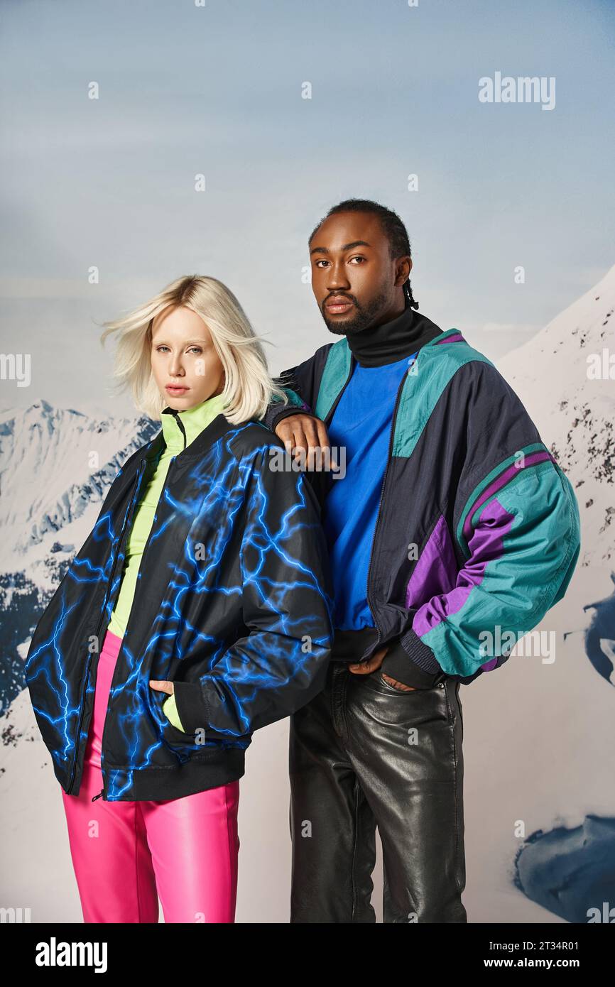 attractive young interracial couple in warm stylish attire looking at camera, winter concept Stock Photo