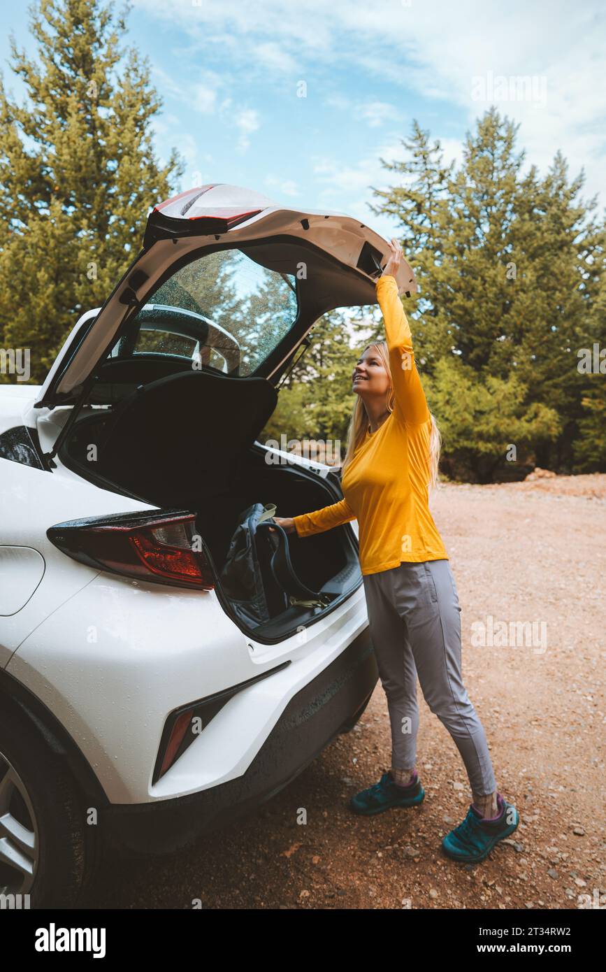 Woman traveling by rental car road trip summer vacations active lifestyle outdoor Stock Photo