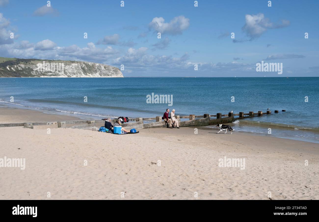 Holidamakers on the sandy beach at Swanage on the South Coast of ENgland in Dorset. Stock Photo