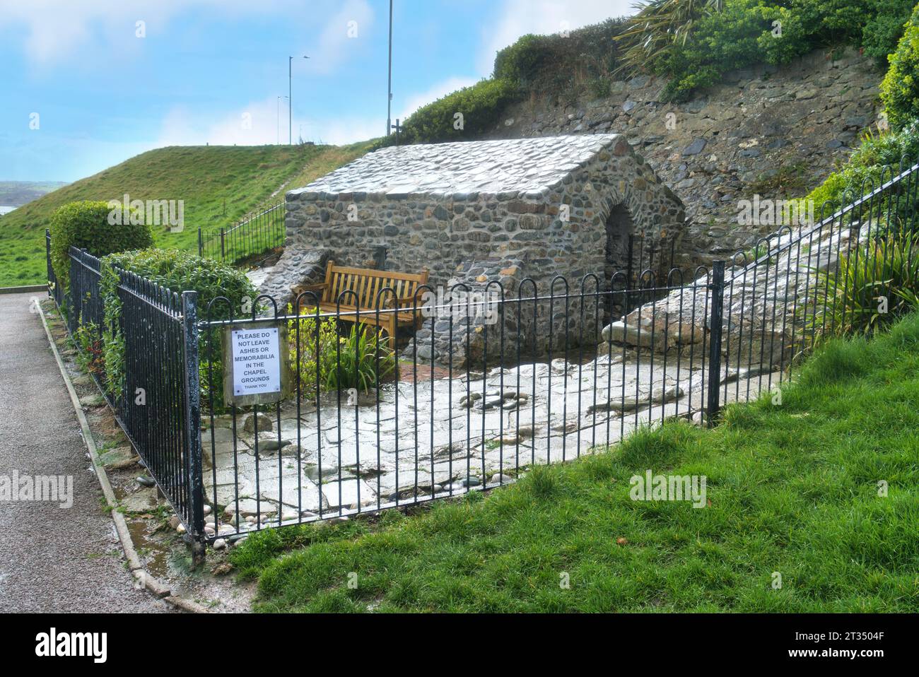 Ancient tiny historic church and Holy Well, St Trill's Chapel, on the beach, sea front at  Rhos-on-Sea;.    Looking north to wlsh coast and Irish sea Stock Photo