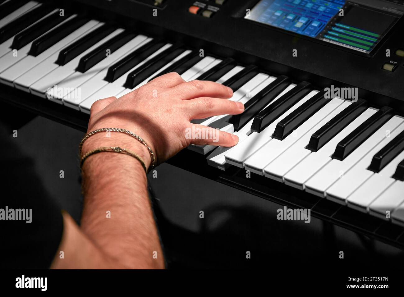 Image of the pianist's right hand on the keys of the instrument Stock Photo