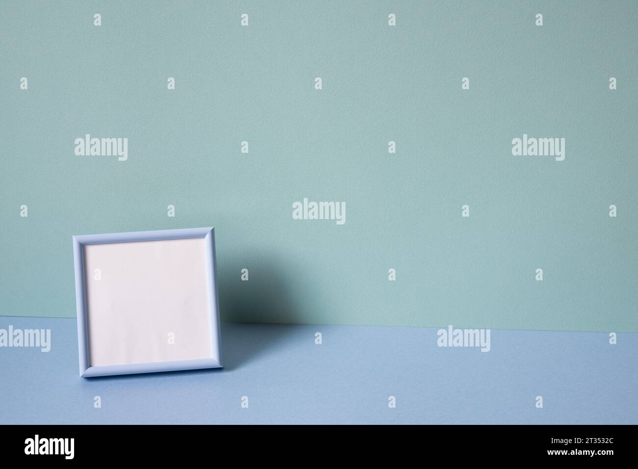 Blank picture frame on mint blue background. copy space Stock Photo