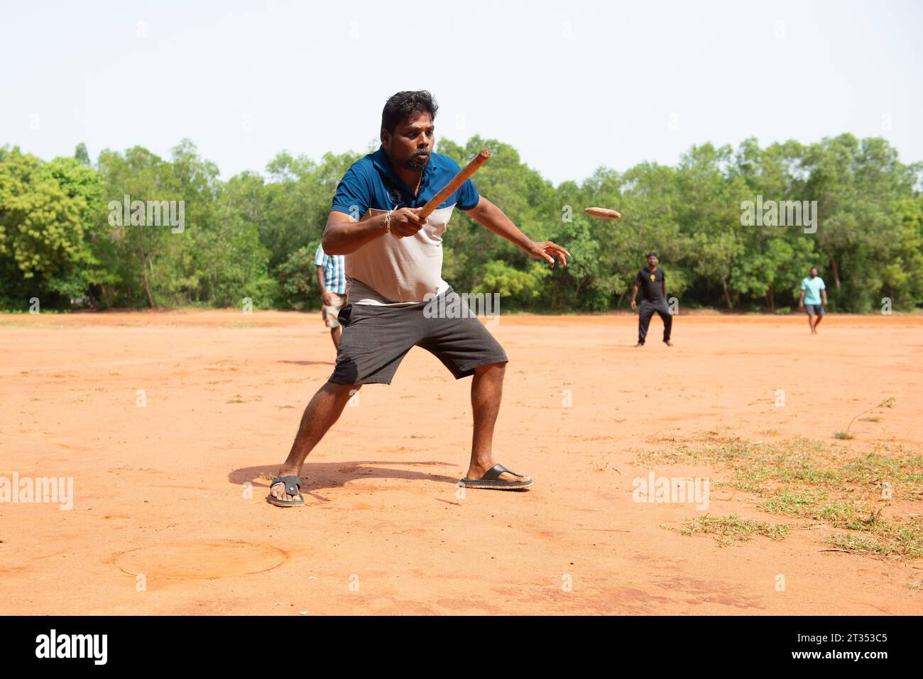 Auroville, India - August 2023: Playing Gilli Danda, the traditional indian game that is believed to be the origin of games such cricket and baseball Stock Photo