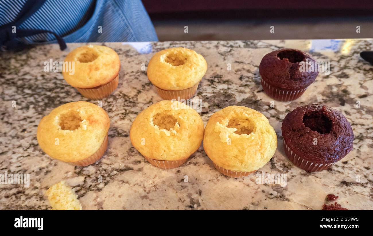Filling Vanilla, Chocolate Cupcakes with Lemon, Raspberry Stock Photo