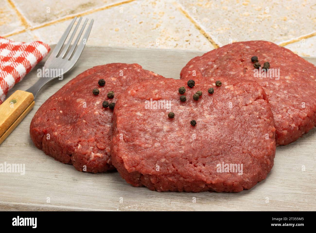 raw beef minced steaks, close-up, isolated on a table Stock Photo