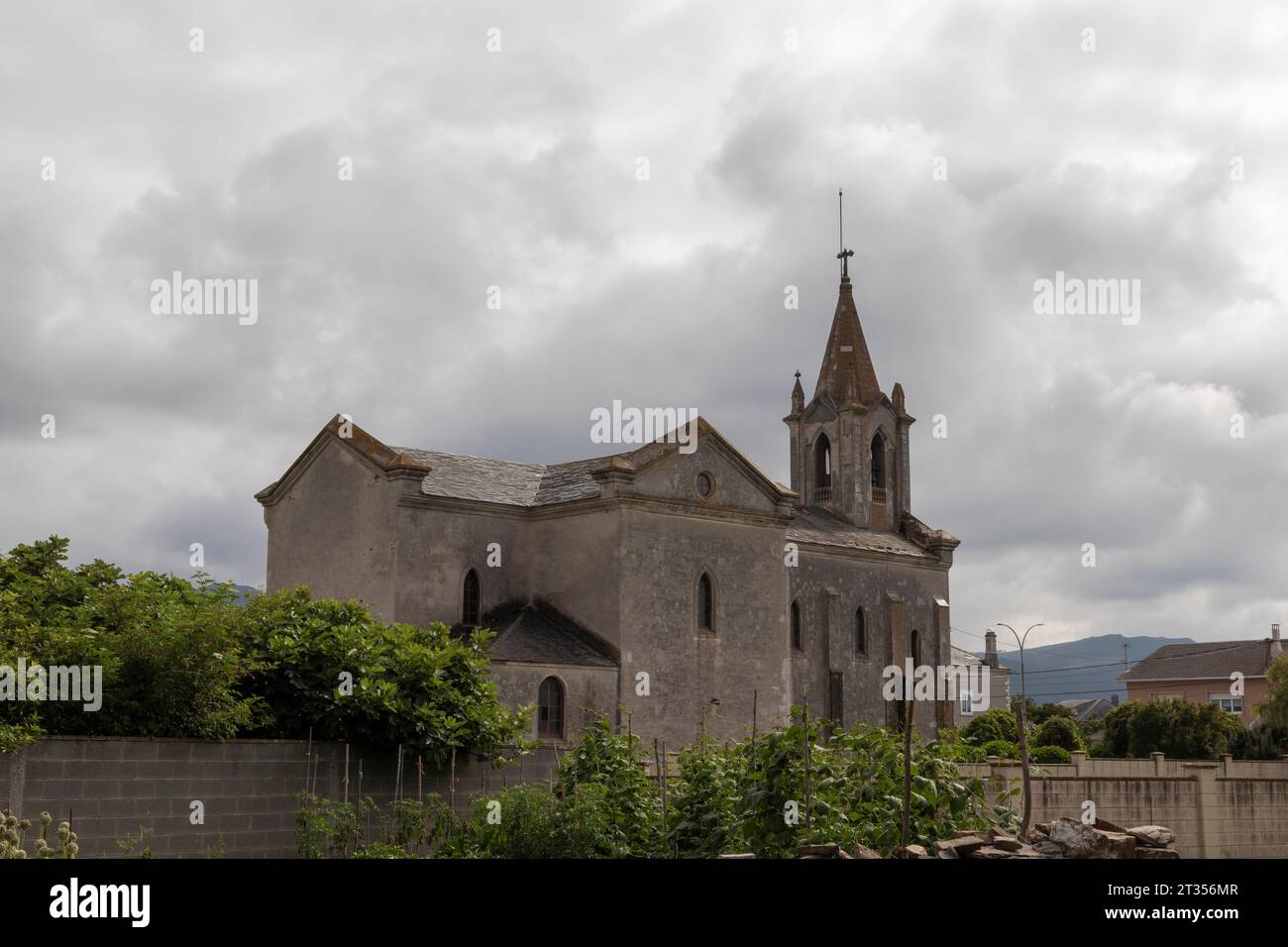 Historic Stone Church Under Cloudy Sky in a Small Town Stock Photo - Alamy