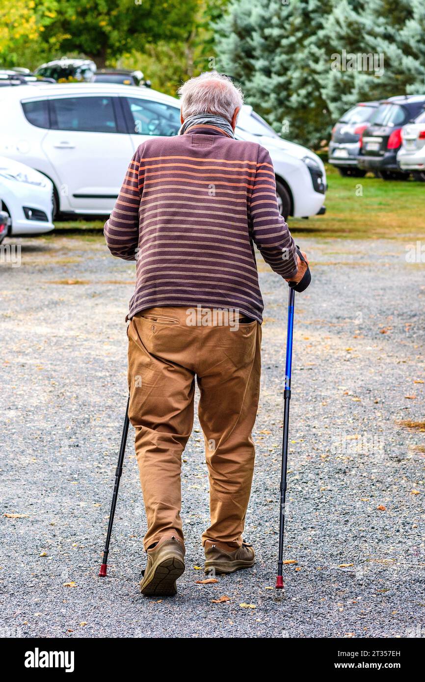 Man with walking canes - France. Stock Photo