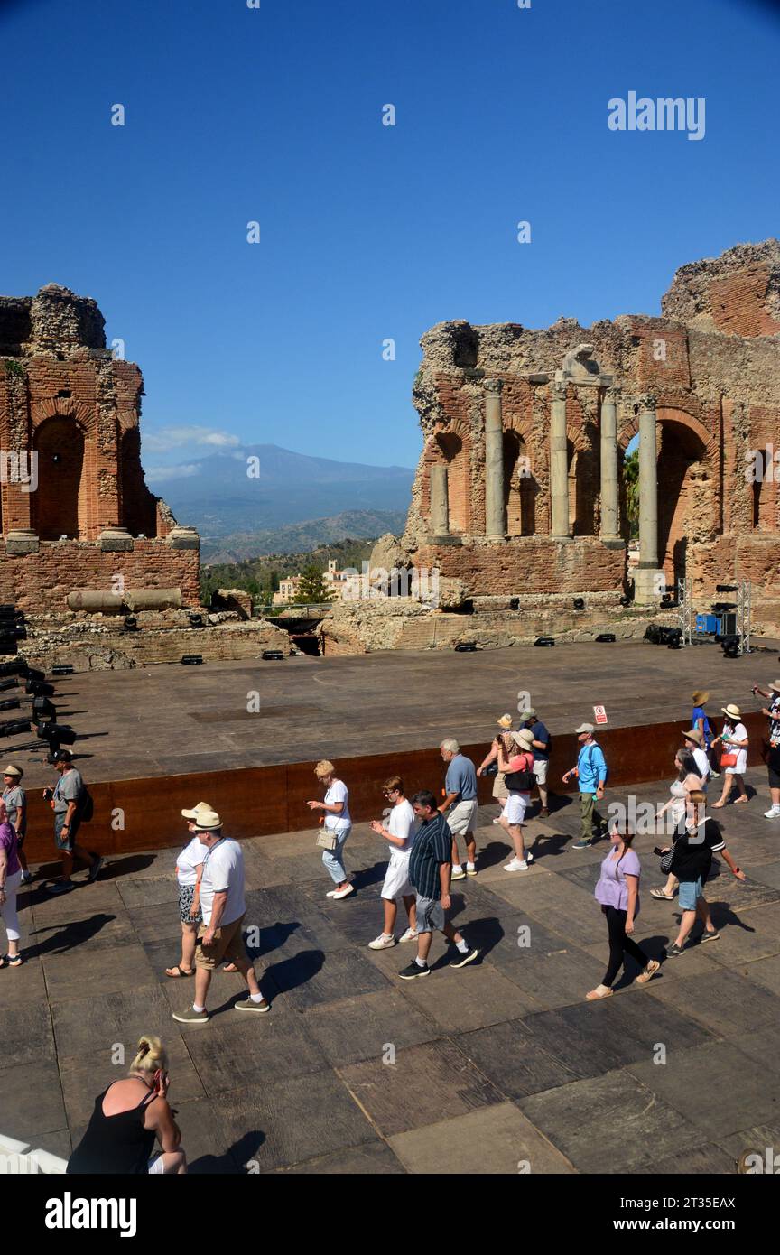 Mount Etna Volcano and Tourists in the Ruins of the Ancient Greek