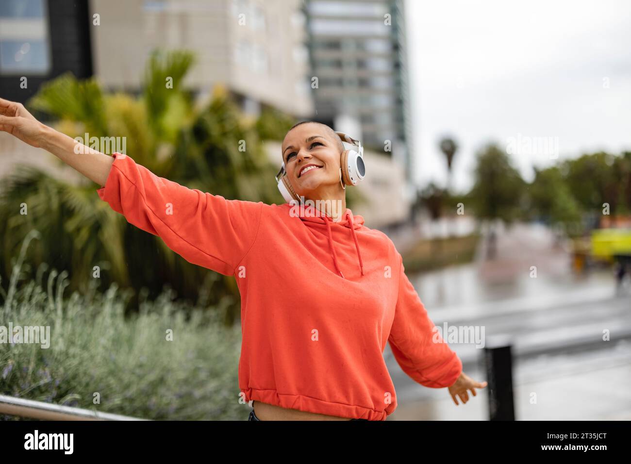 Carefree woman enjoying music and dancing Stock Photo