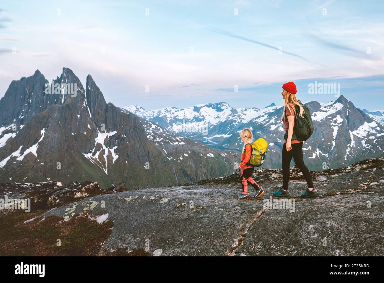 Adventure vacation in Norway: Active family hiking on scenic mountain trails Mother and child explore the outdoors discovering Senja island healthy li Stock Photo
