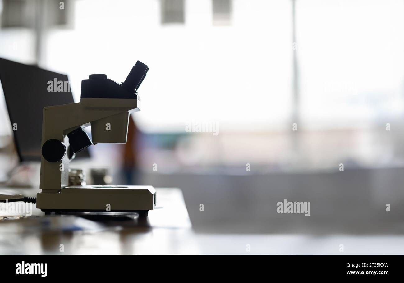 Microscope in a laboratory - on a white wall - empty space for text ...