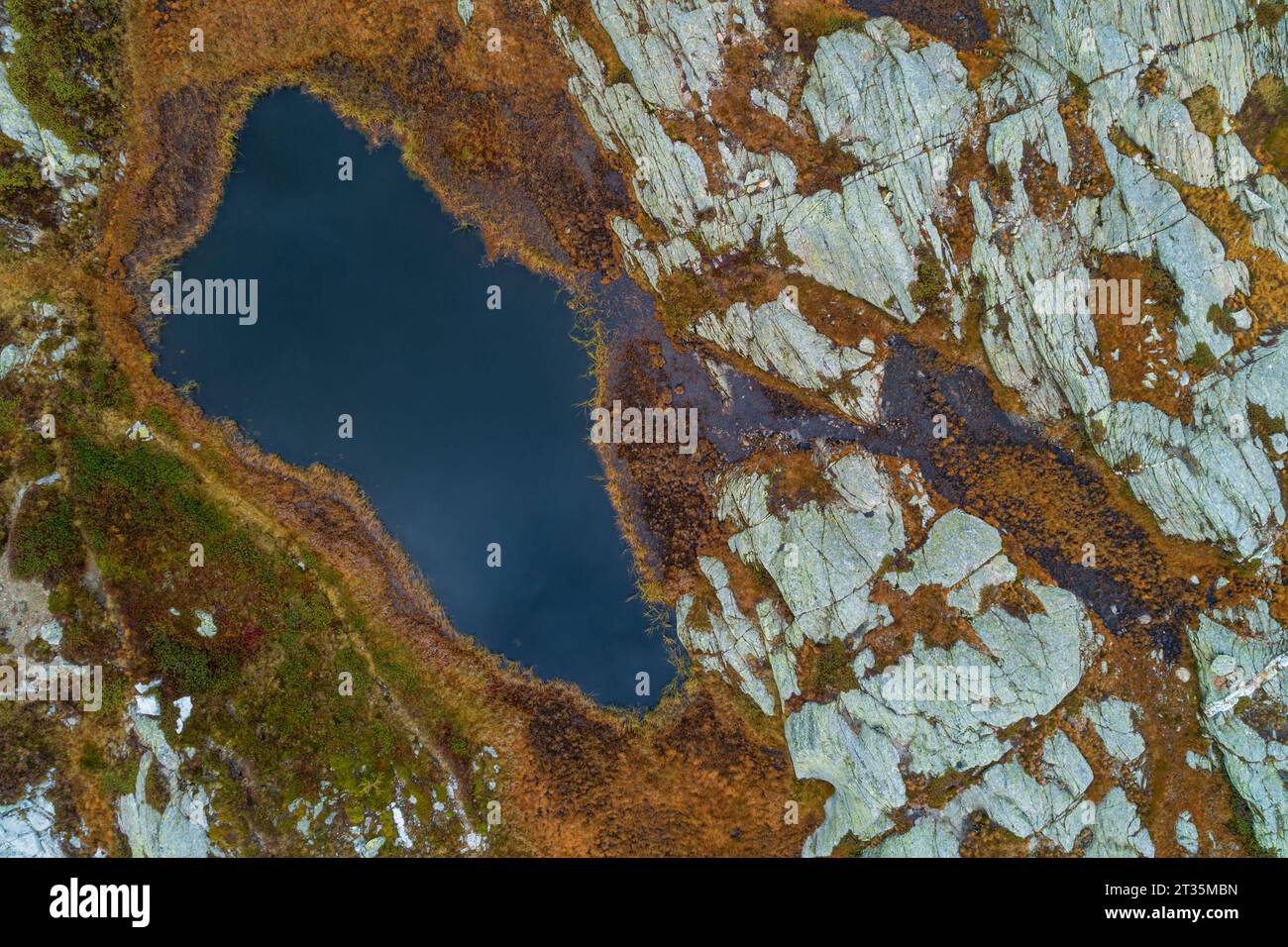 Switzerland, Graubunden Canton, Aerial view of small alpine lake in San Bernardino Pass area Stock Photo