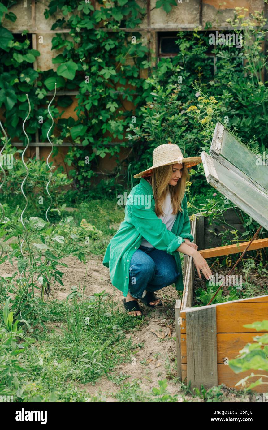 Woman planting seeds in greenhouse Stock Photo - Alamy