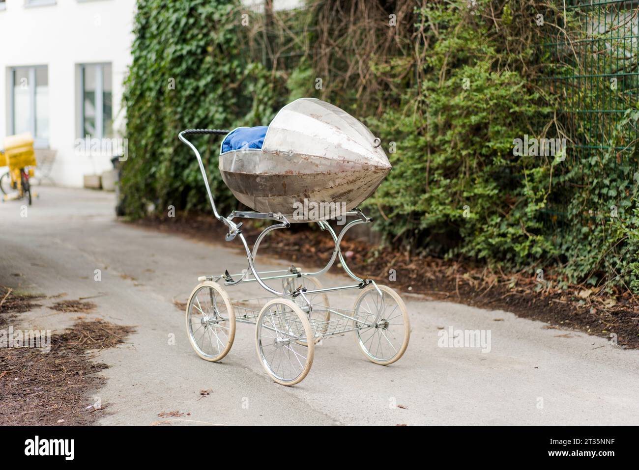 Abandoned baby stroller on road Stock Photo