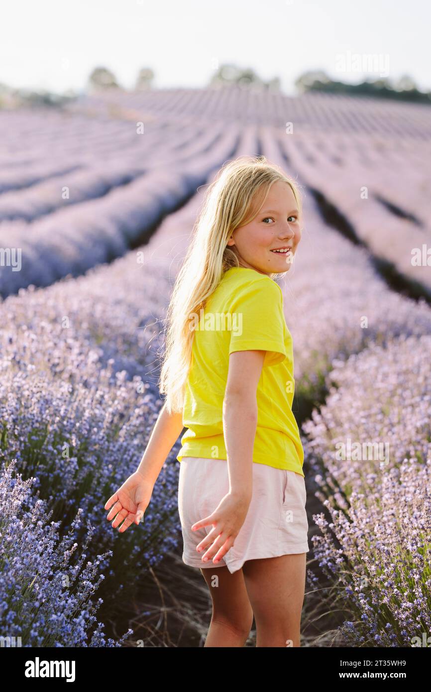 Playful girl spending leisure time in lavender field Stock Photo
