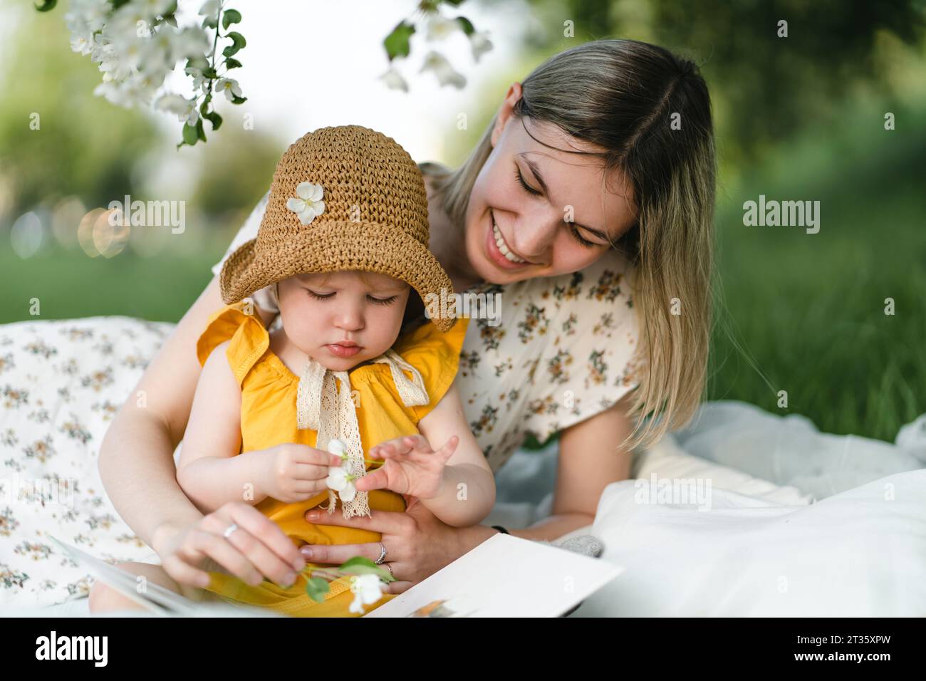 Smiling mother and daughter spending leisure time in garden Stock Photo