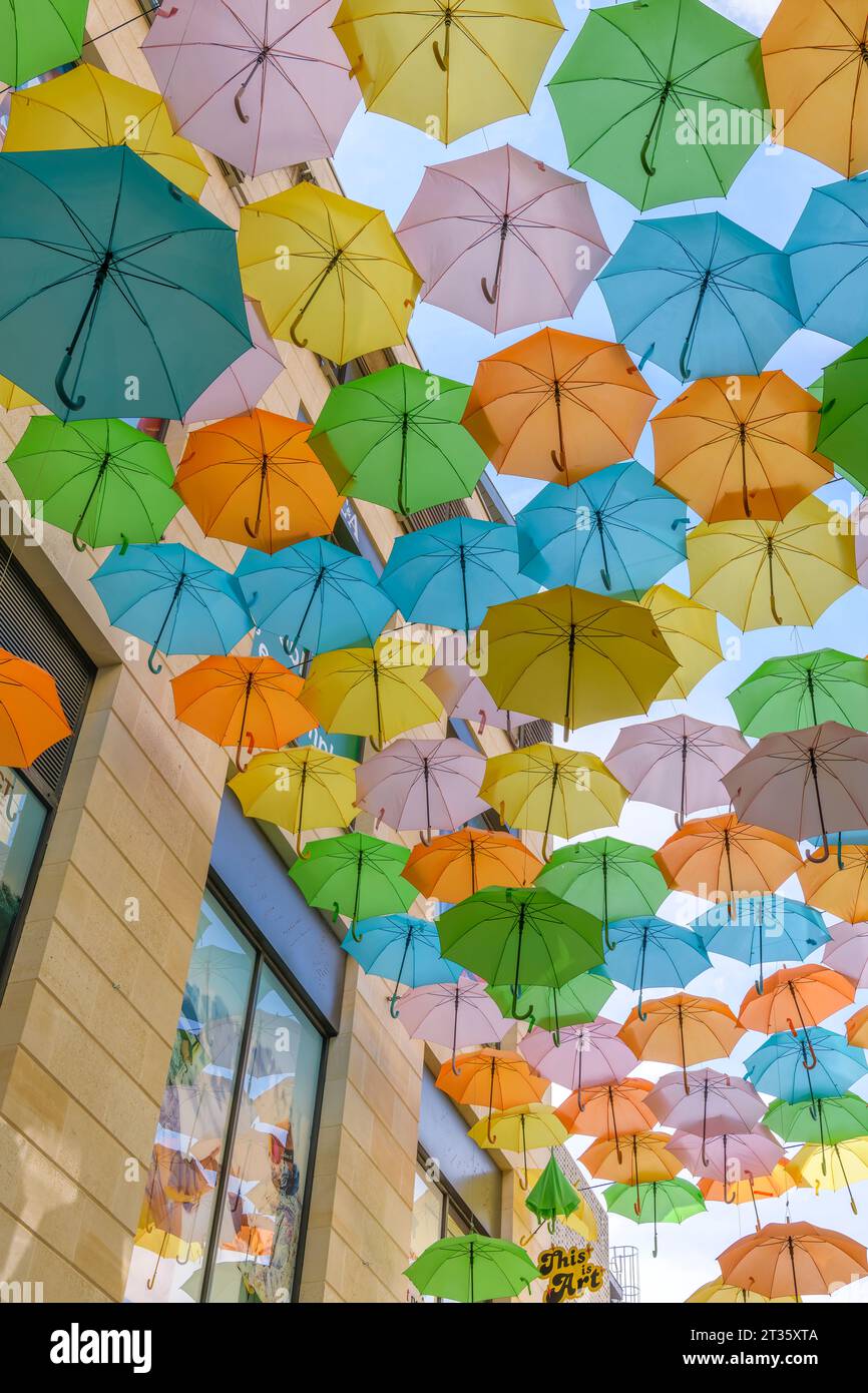 Bordeaux Sainte-Catherine shopping centre in Bordeaux, festooned with dozens of rainbow-coloured umbrellas, in pinks, oranges, teals and blues. Stock Photo