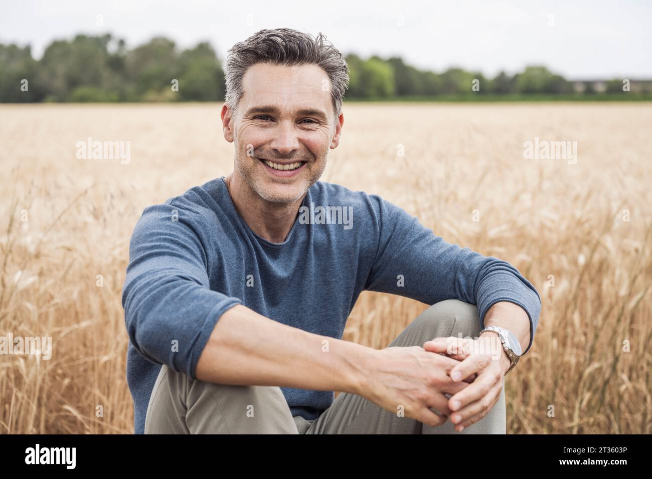 Happy man sitting hi-res stock photography and images - Alamy