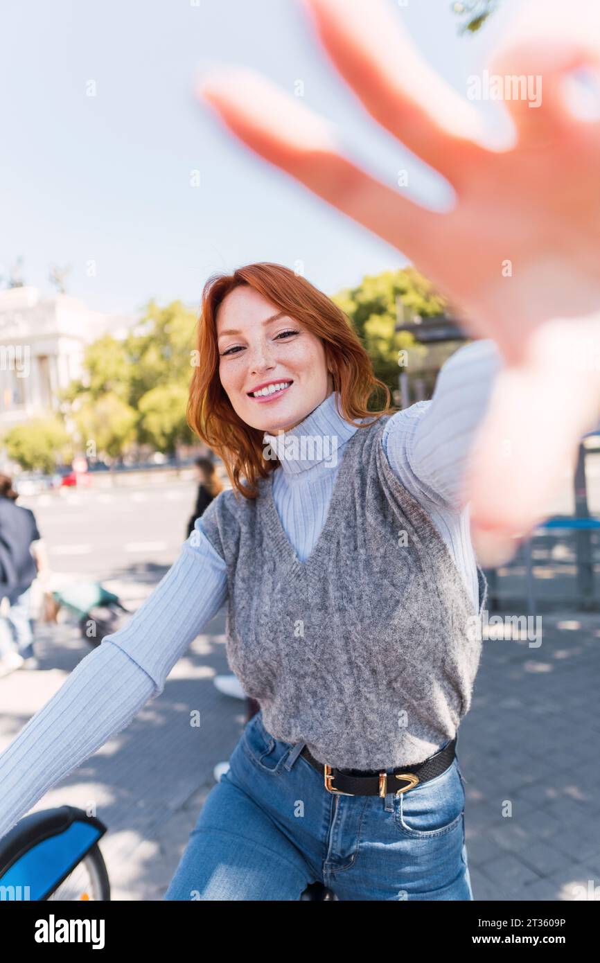 Happy woman gesturing on sunny day Stock Photo