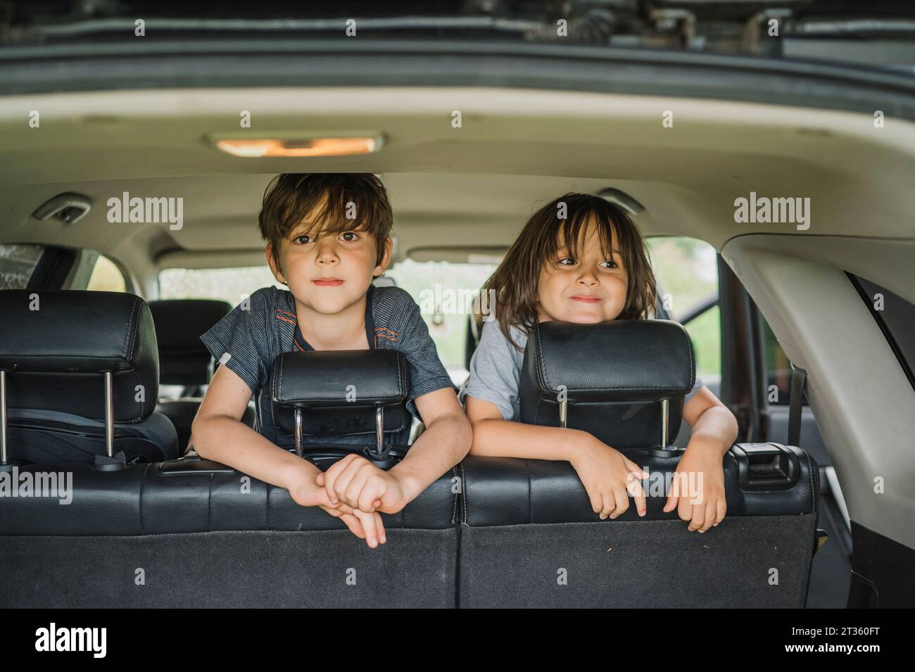Smiling boys spending leisure time in car Stock Photo