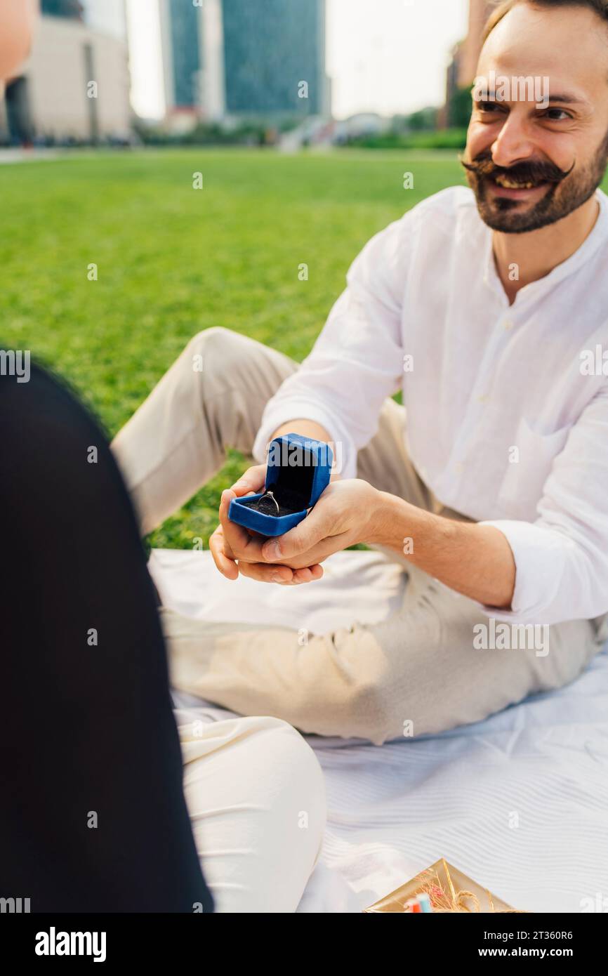 Happy man proposing woman with ring Stock Photo