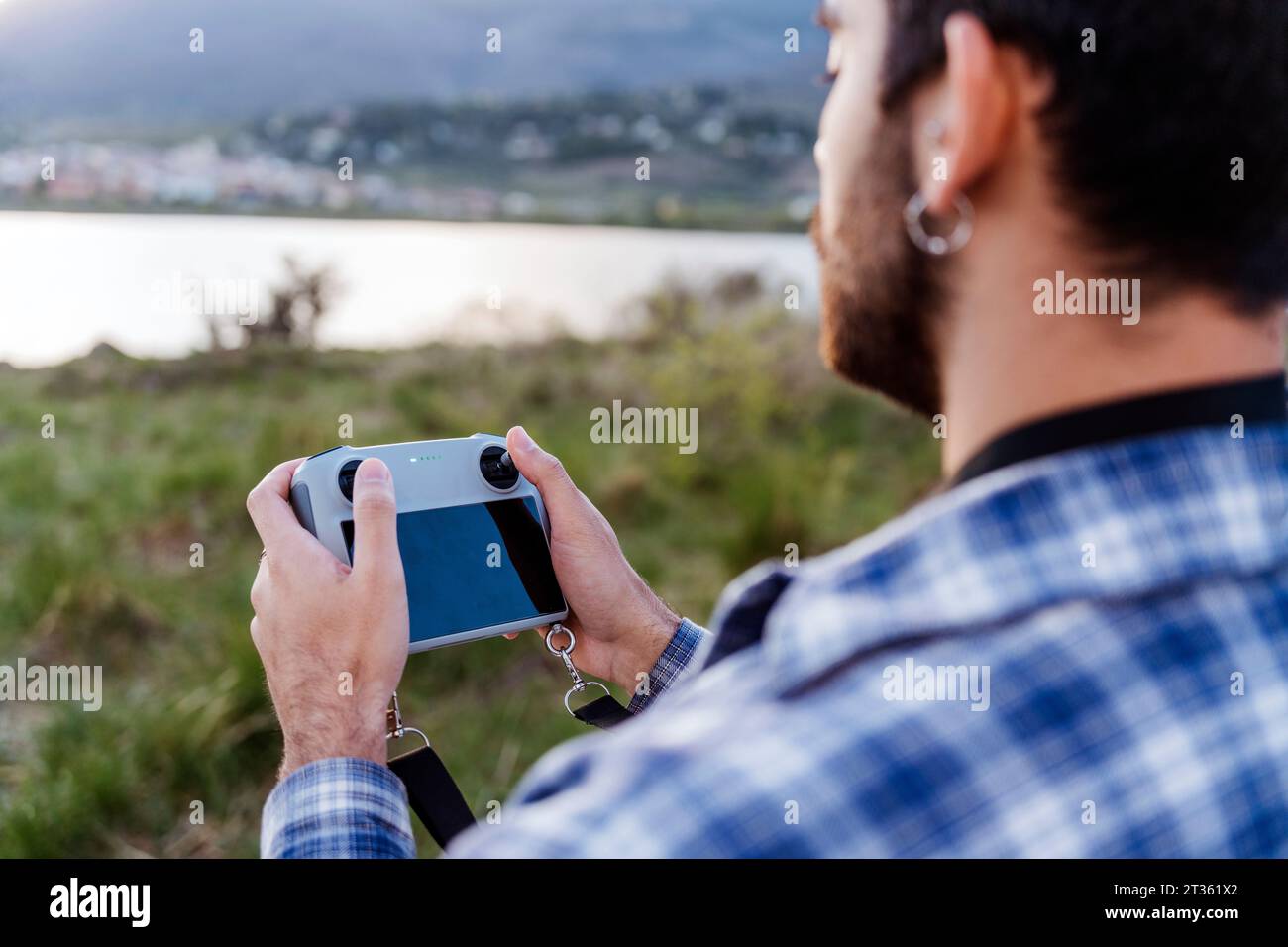 Man operating drone through controller Stock Photo