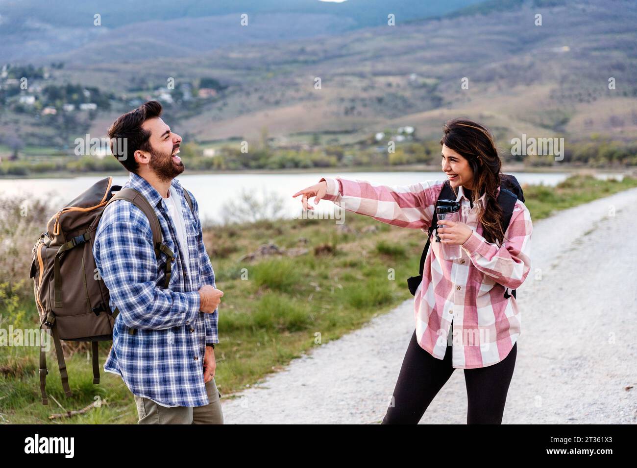 Happy tourists having fun standing on footpath Stock Photo