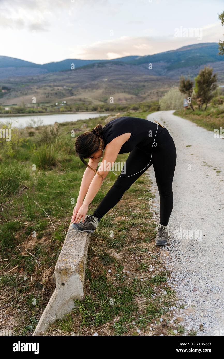 Young woman stretching near hi-res stock photography and images - Alamy
