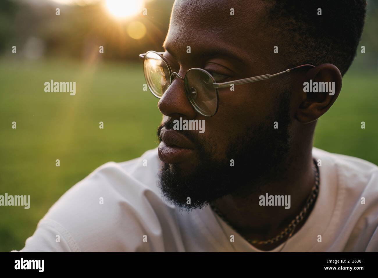 African man thinking contemplative park hi-res stock photography and ...