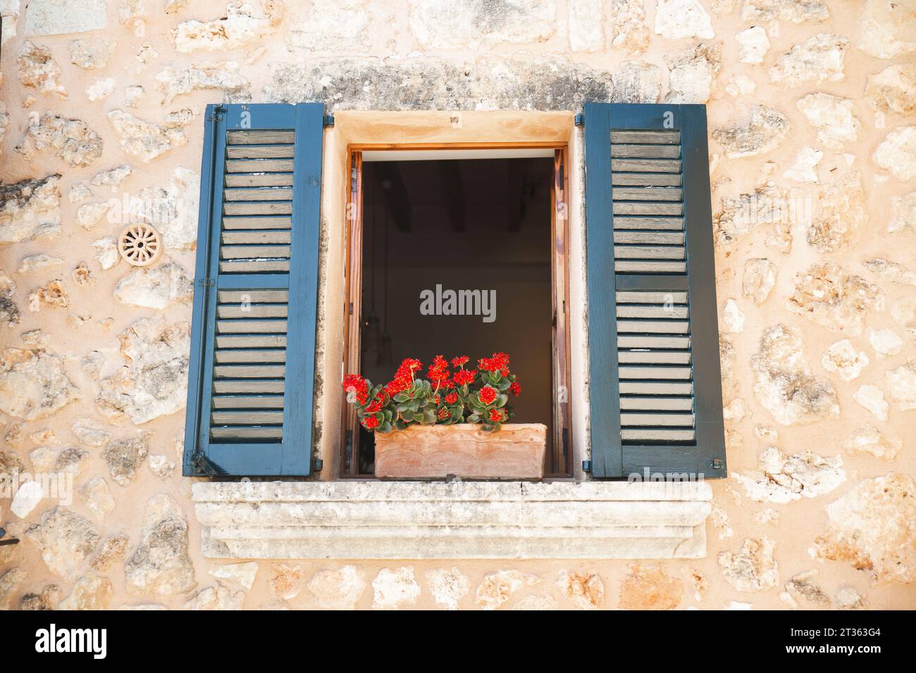 Window with red flower pot Stock Photo