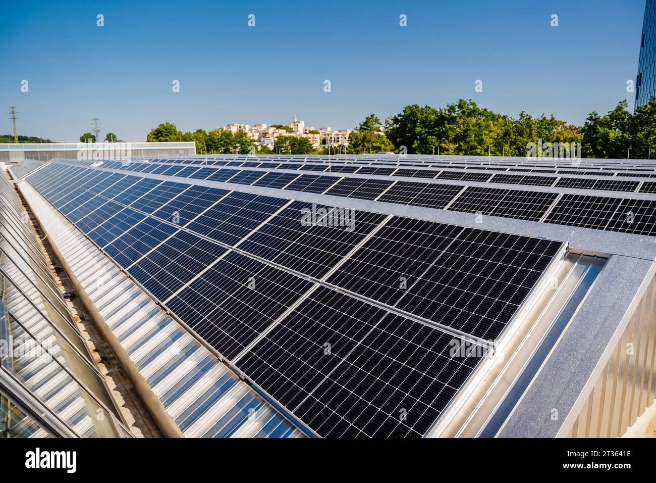 Solar panels on the roof of a building under blue sky Stock Photo
