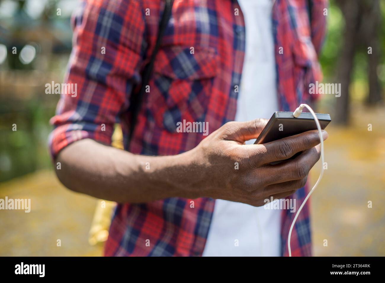 Hand of young man using smart phone Stock Photo