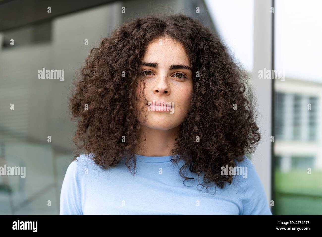 Beautiful young woman with curly hair Stock Photo - Alamy