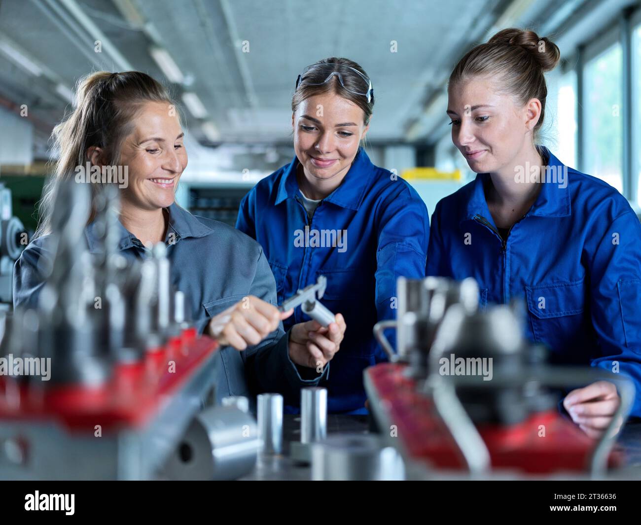 Metal worker teaching trainees to measure CNC tool at factory Stock Photo Alamy