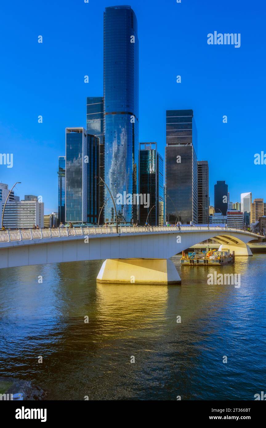 Australia, Queensland, Brisbane, Skyline of riverside city with bridge in foreground Stock Photo